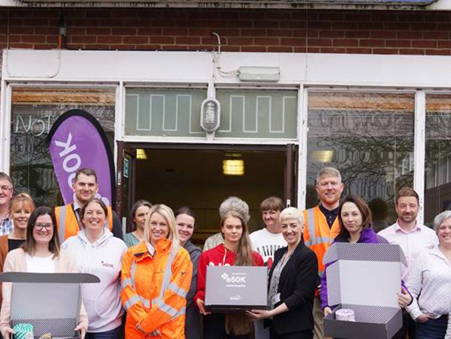 Multiple people standing in front of a shop window