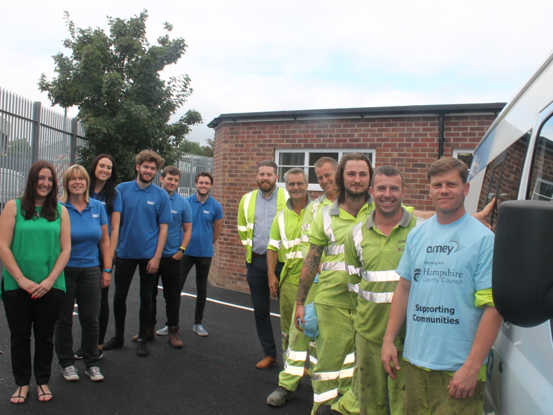 Image of people stood in front of a building.