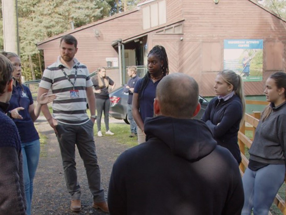 Group of people standing around in a circle.