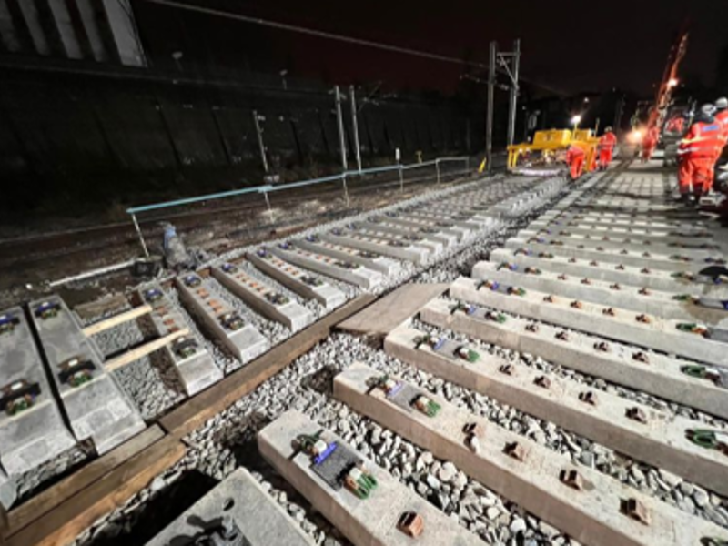 Amey employees, working on a rail track at night.