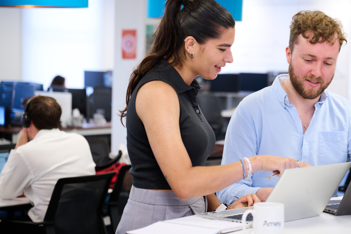 Image of two Amey employees looking at a laptop