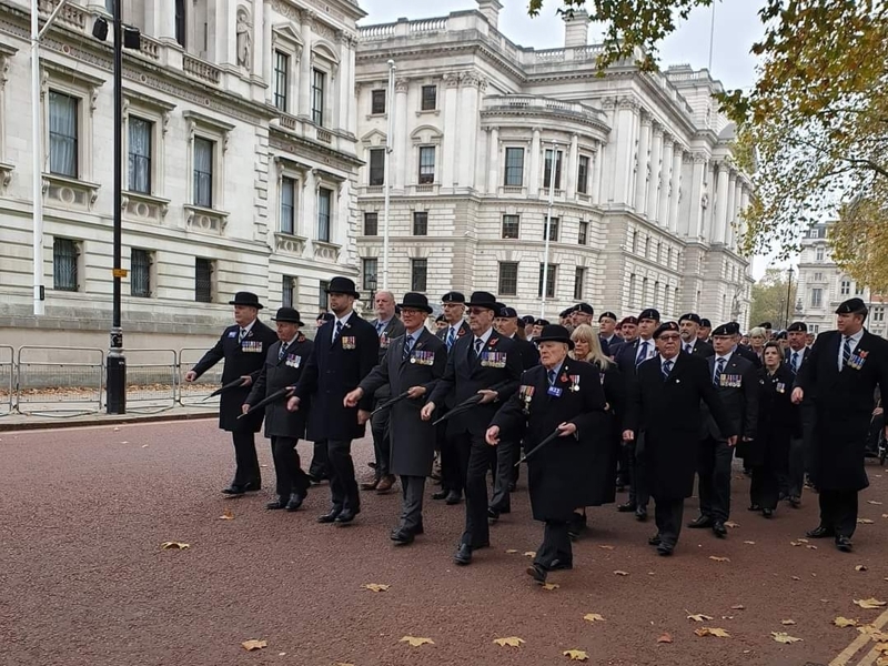 Image of military personnel walking down a road.