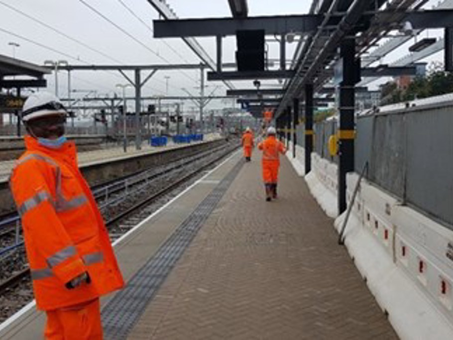 Amey employees on the side of a train platform