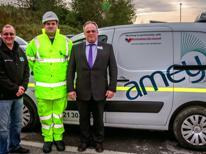 Three men stood in front of an Amey van.