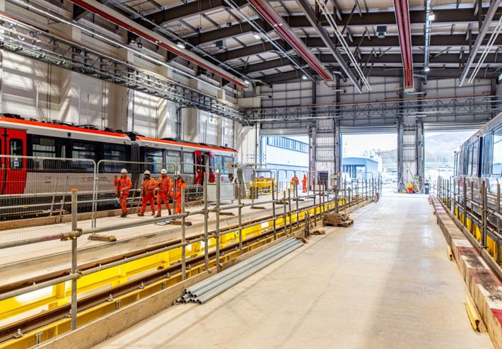 Image of a contruction site within a train station, with multiple Amey employees working