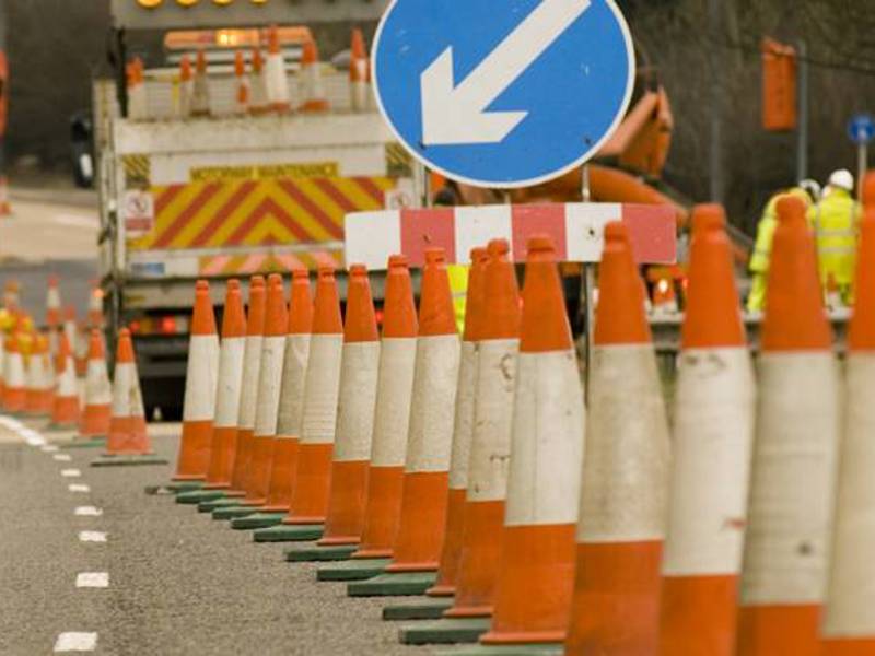 Image of a row of traffic cones on a highway.