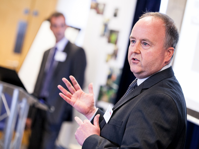 A male presenting to an audience. 