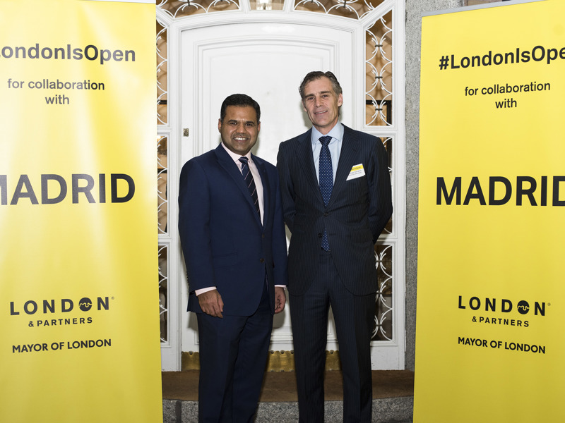 Two men, in formal attire at a conference in London.