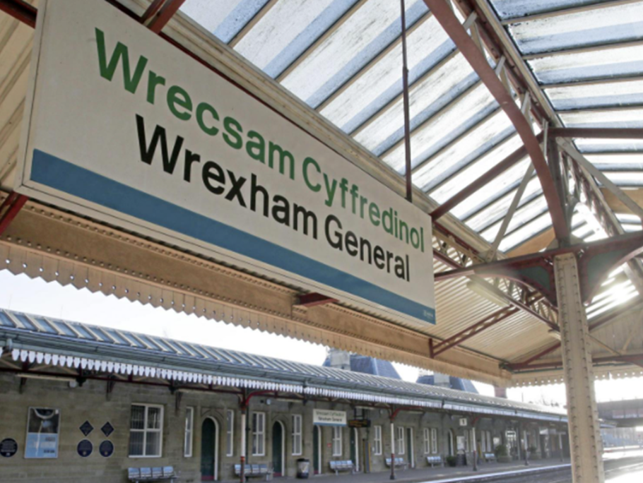 Image of a Station sign at a train platform.