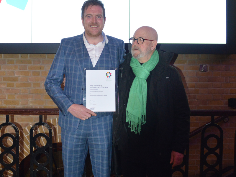 two men holding a certificate.