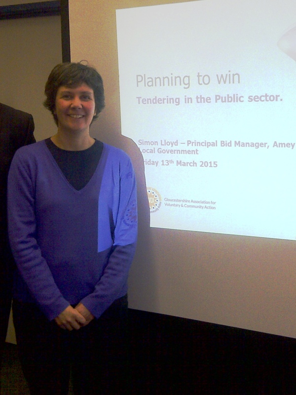 Man and woman stood in front of a presentation.