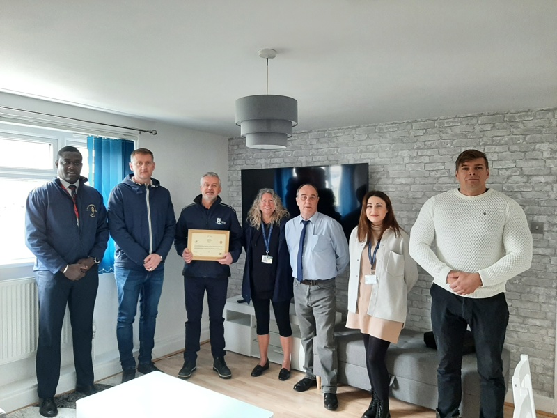 Image of Amey employees holding a certificate.