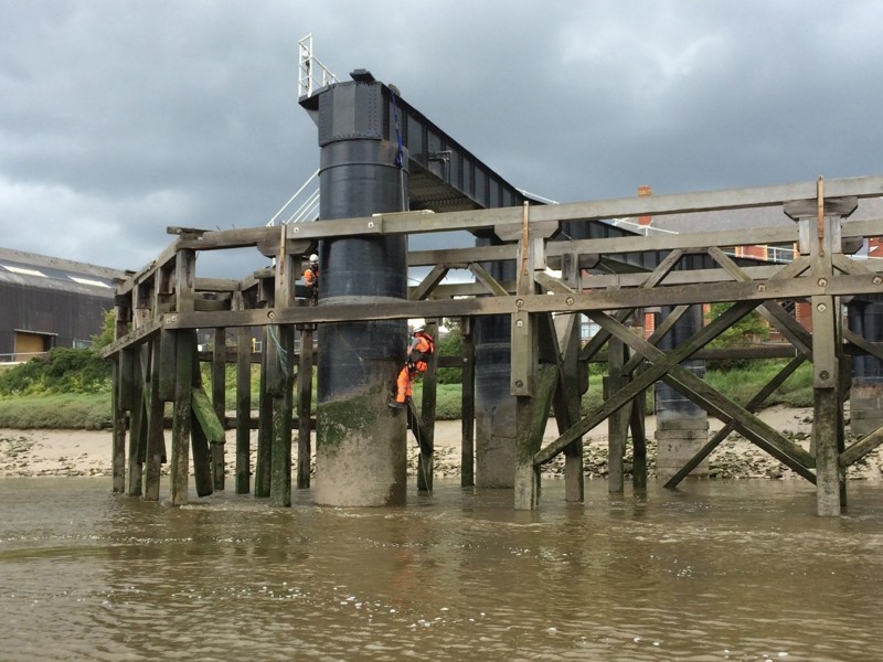 Two men carrying out maintenance work. 