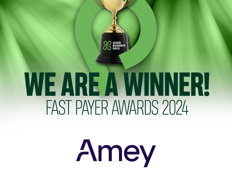 A graphic celebrating Amey as a winner of the Fast Payer Awards 2024, organised by Good Business Pays. It features a gold trophy on a green background with the text "WE ARE A WINNER!" prominently displayed. The Amey logo is visible at the bottom.