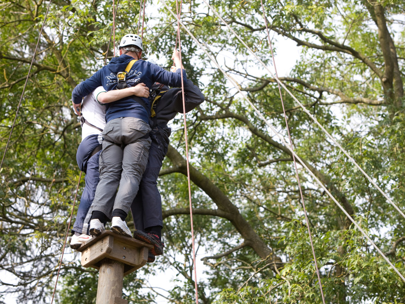 Image of Amey employees zip lining. 