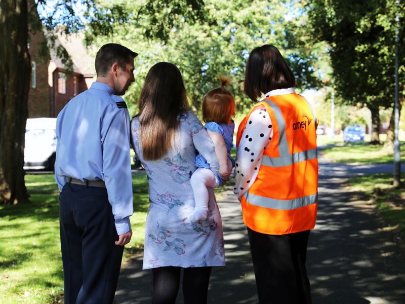 an image of a family taken from behind.