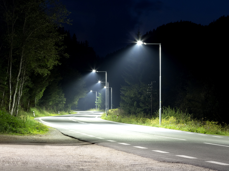 a road lit up with street lighting