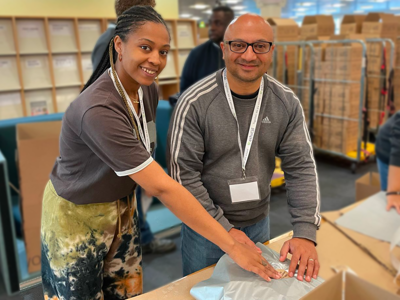 Image of two Amey employees packing hampers.