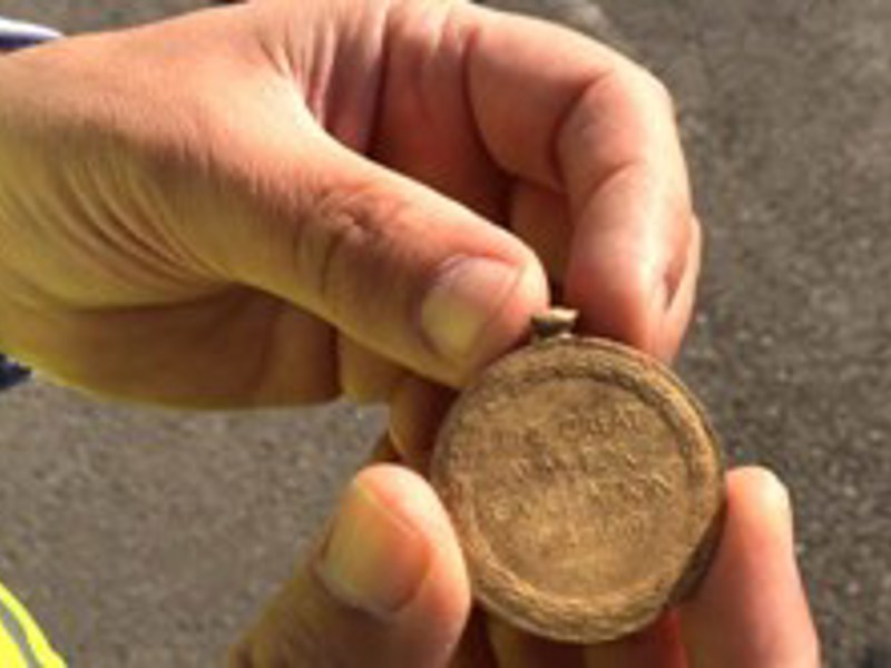 Male holding a pocket watch.