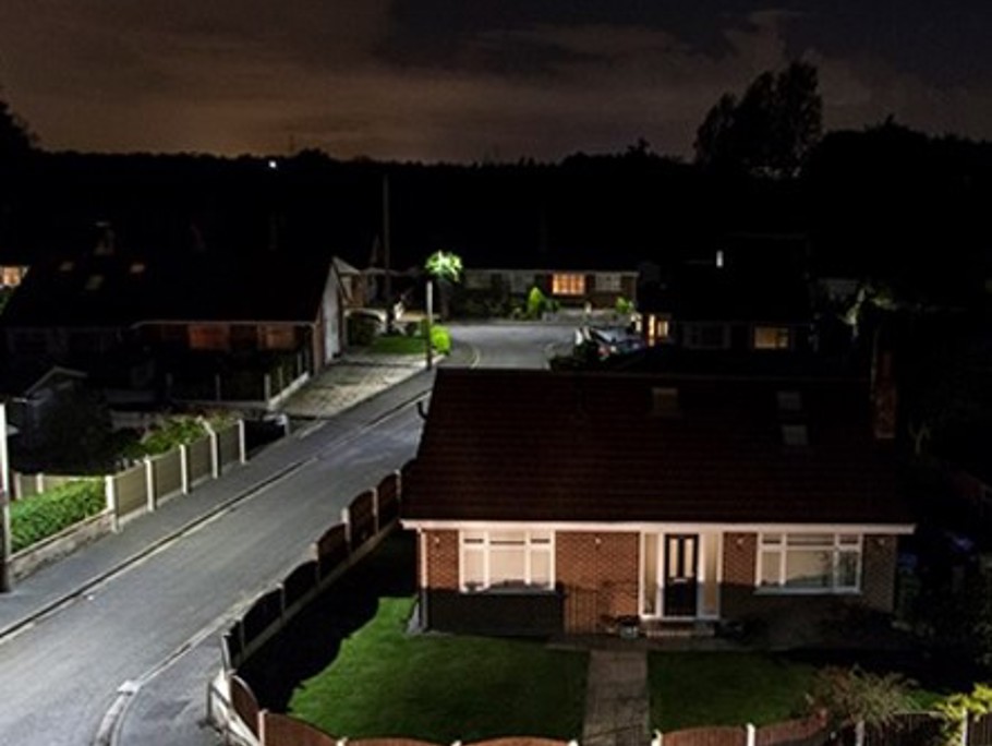 Image of a house and LED street lighting, taken at night.