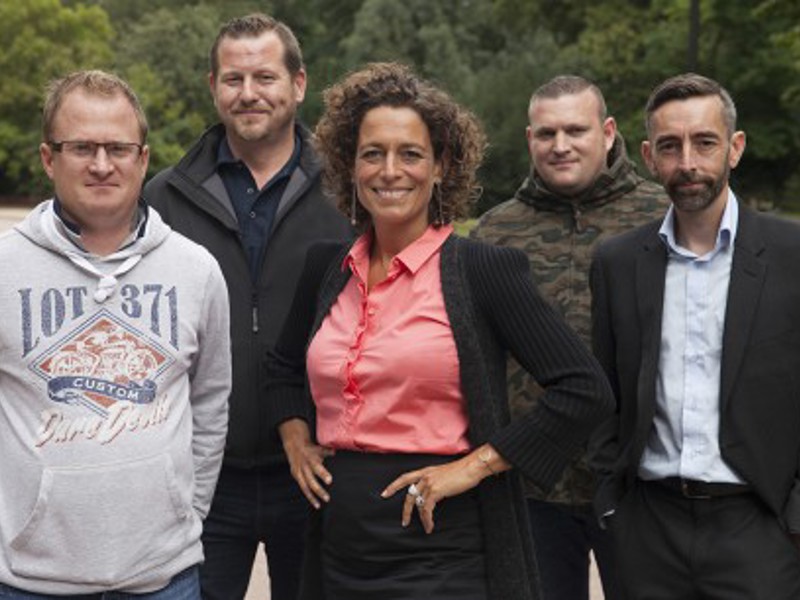 A group of people stood in a field.