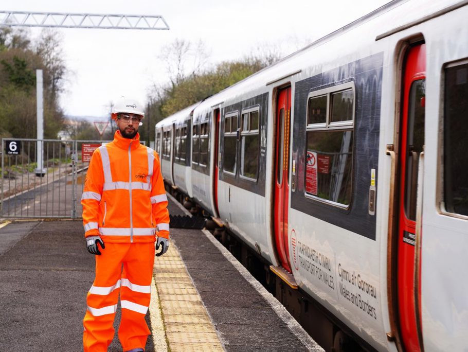 Amey employee standing next to a stationary train on the platform