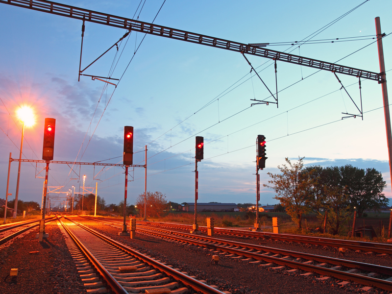 Rail tracks and traffic control lights.