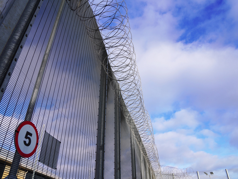 image of a barbed wire prison fence.