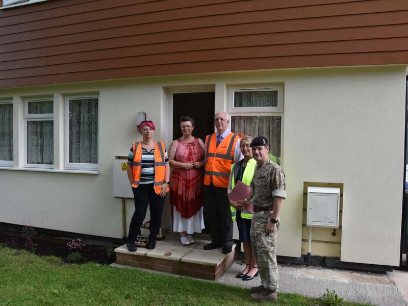 Personnel stood in front of a home