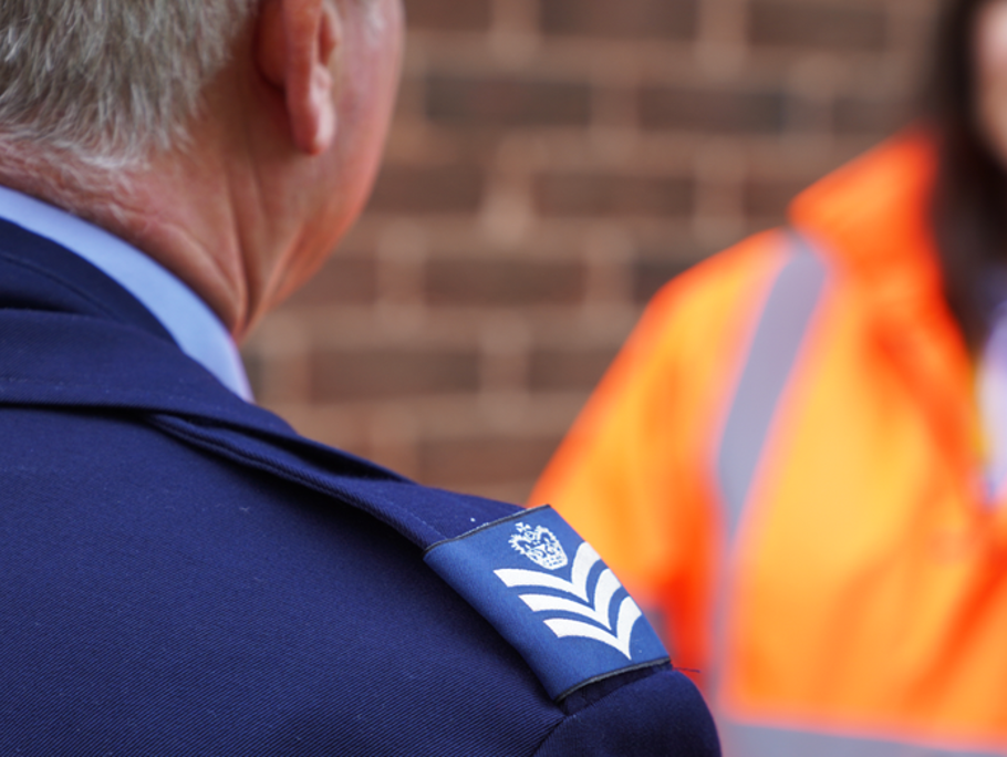 Image of a military man speaking to an Amey employee.