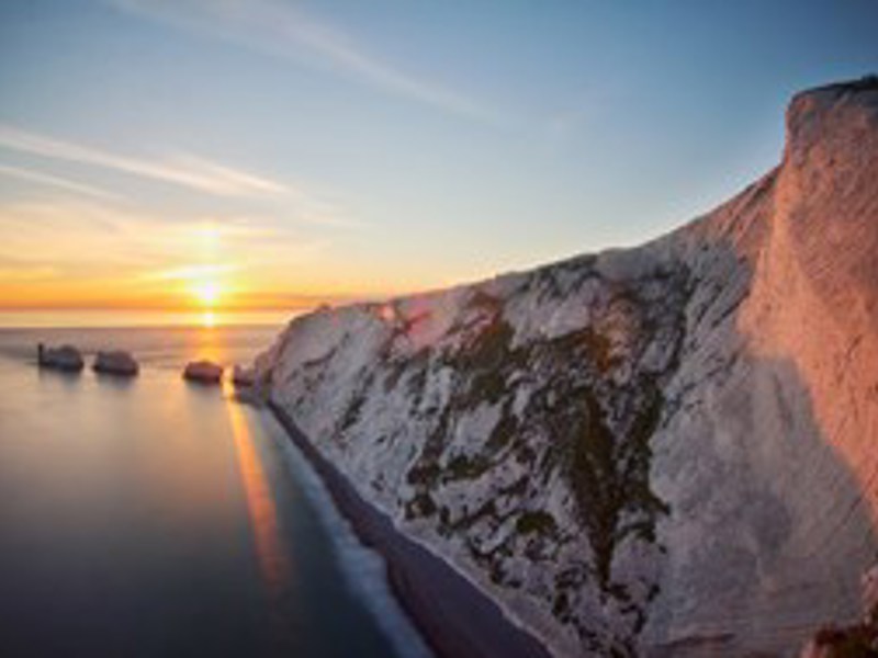 Image of a cliff besides a beach.