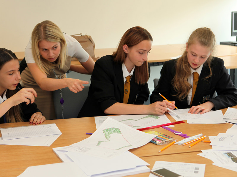 school children working at a desk.