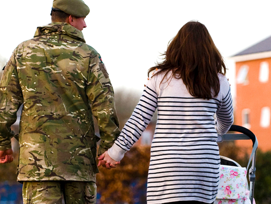 Milartary family with their backs to us