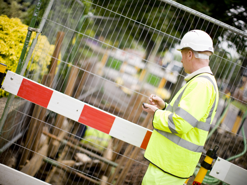 An Amey employee in PPE, carrying out an inspection.