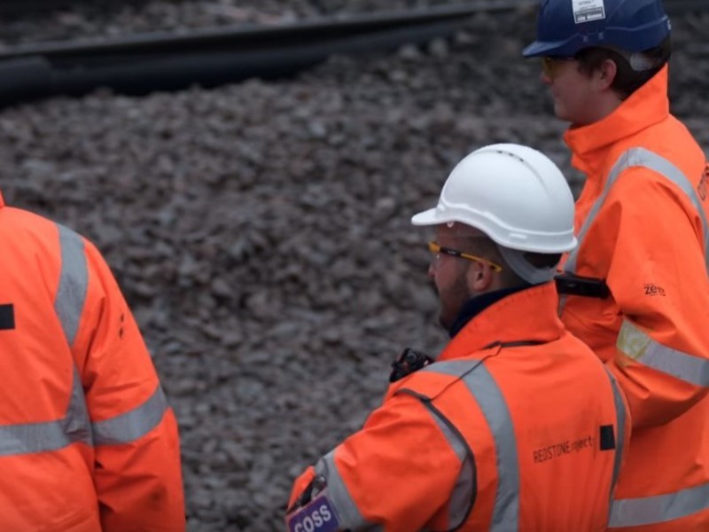 Image of three men in PPE.