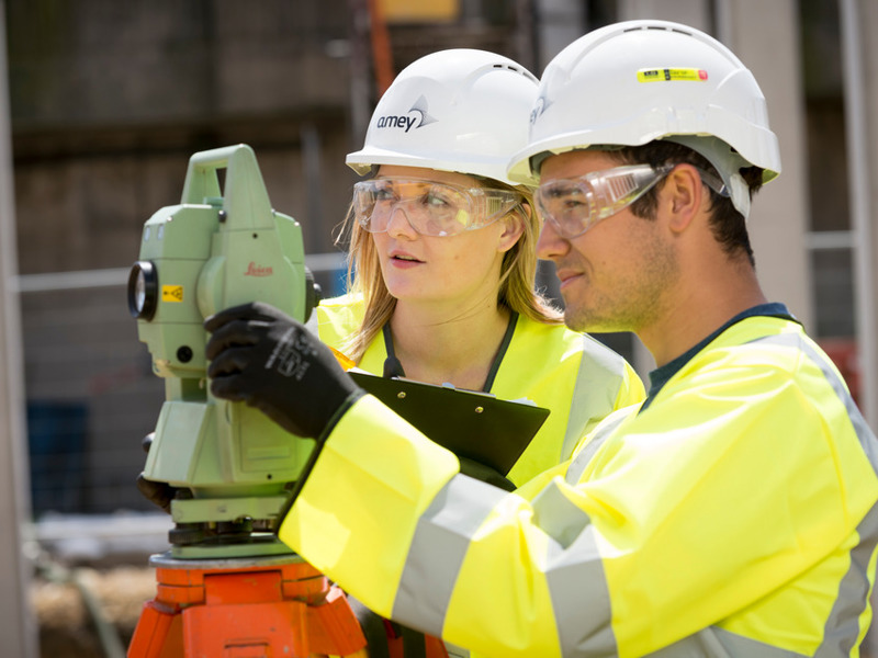 Image of a man and woman looking through binoculars. 