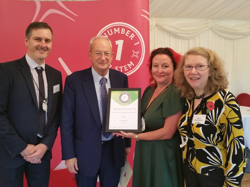 Image of Amey employees being presented with a certificate.